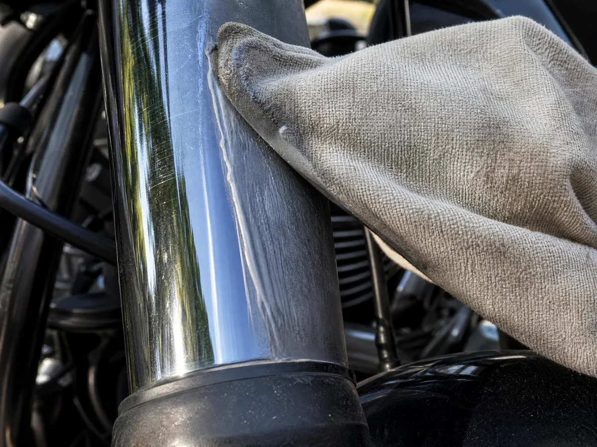 Detailer polishing motorcycle chrome — Scarabbodyworks Detailing in Austin, TX