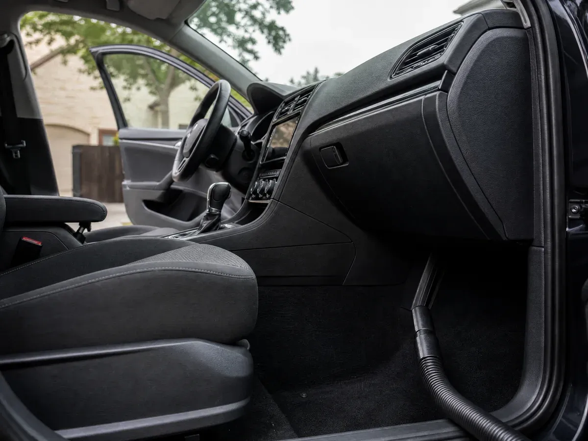 Detailer vacuuming car seats — Scarabbodyworks Detailing in Austin, TX